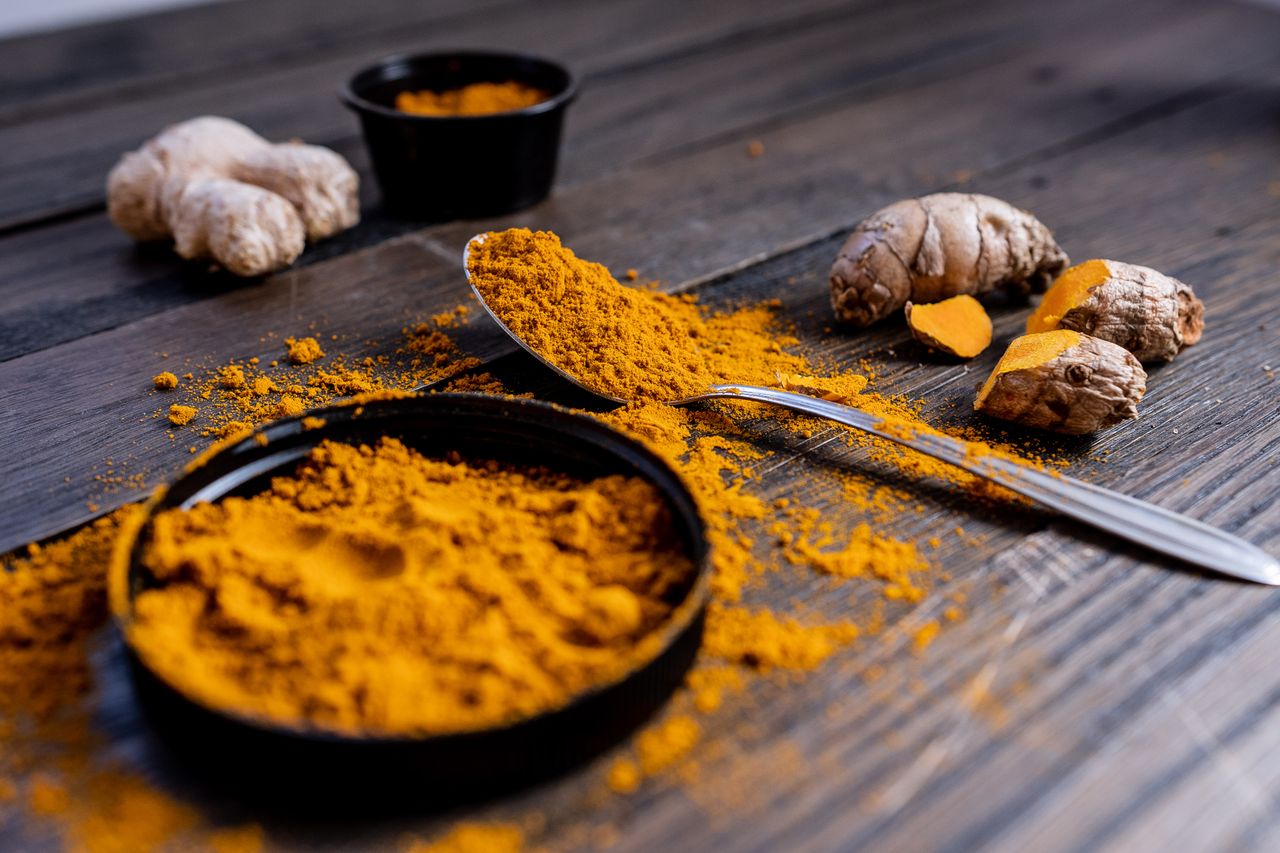 pexels photo 6220708 6220708 1 Vibrant turmeric powder and root arranged on a rustic wooden surface, showcasing culinary spice ingredients.
