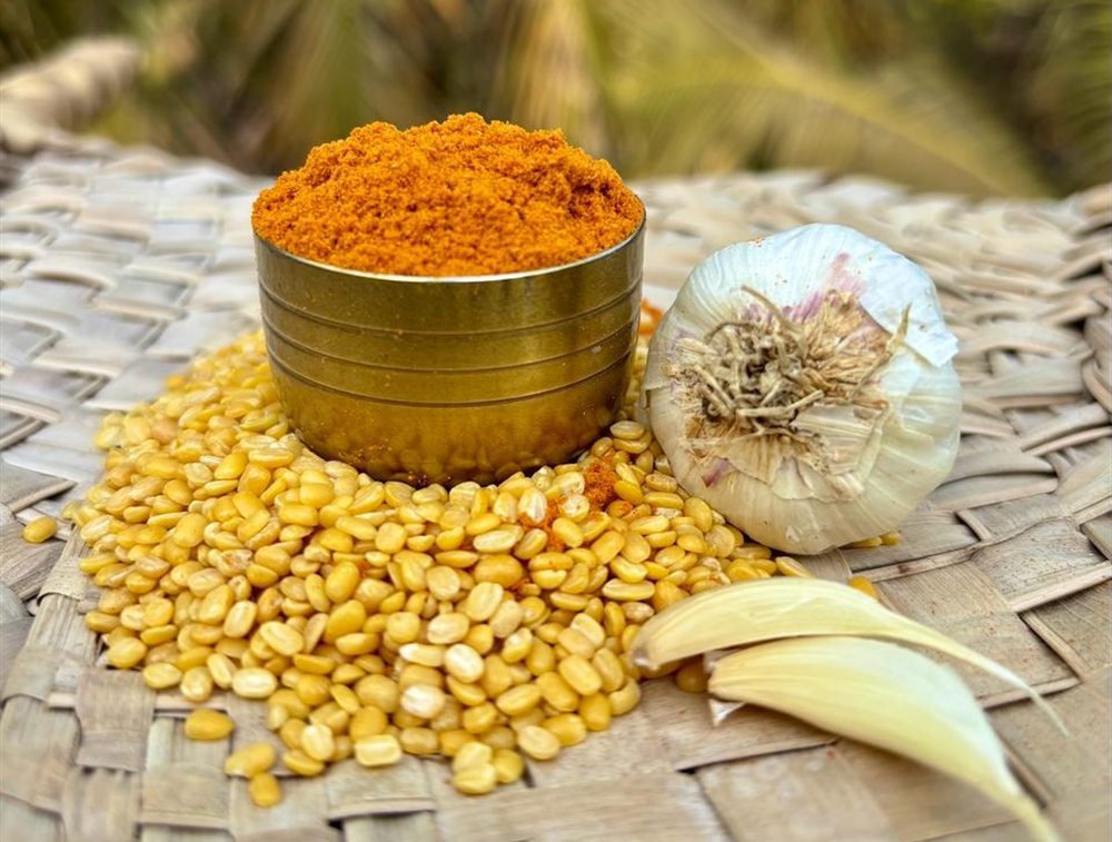 Zest Right masala blend with garlic and dal Freshly ground Zest Right masala in a brass bowl with garlic and split dal