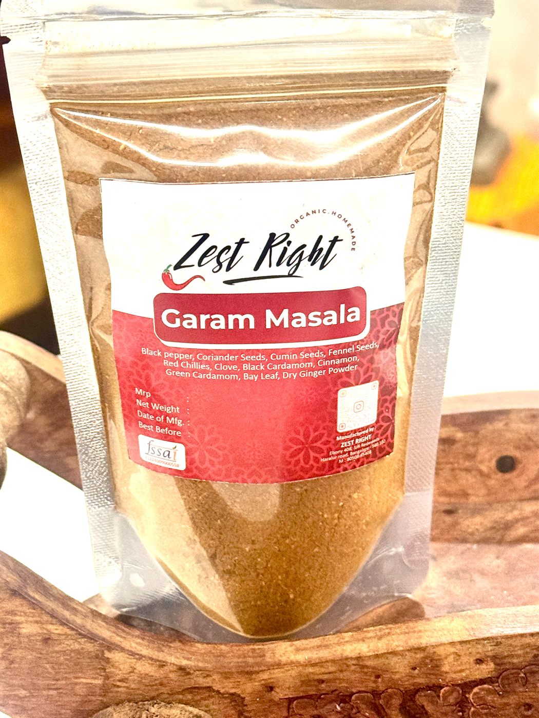 About Us Zest Right garam masala pouch on a wooden board